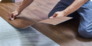 Homeowner standing on durable wood-look flooring – quality floors and pro installation