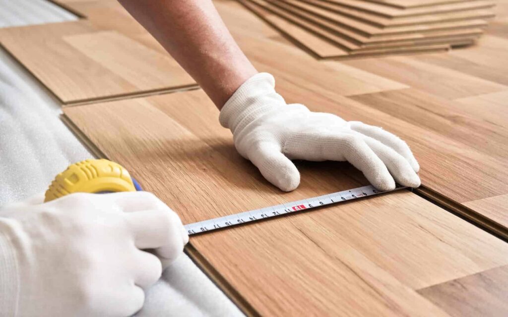 Installer fitting luxury vinyl plank flooring – professional installation by Magic Carpet